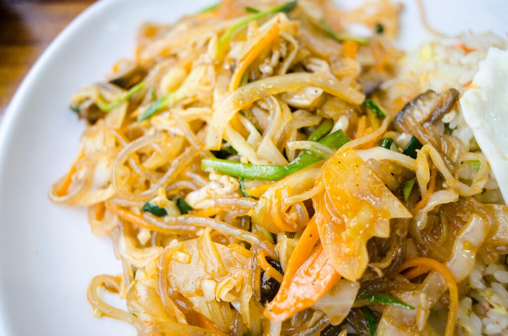 Appetizing stir-fried noodles with vegetables on a plate, perfect for a delicious meal idea.